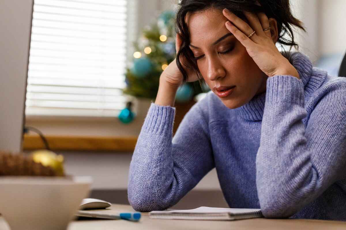 Stressed woman holds her head