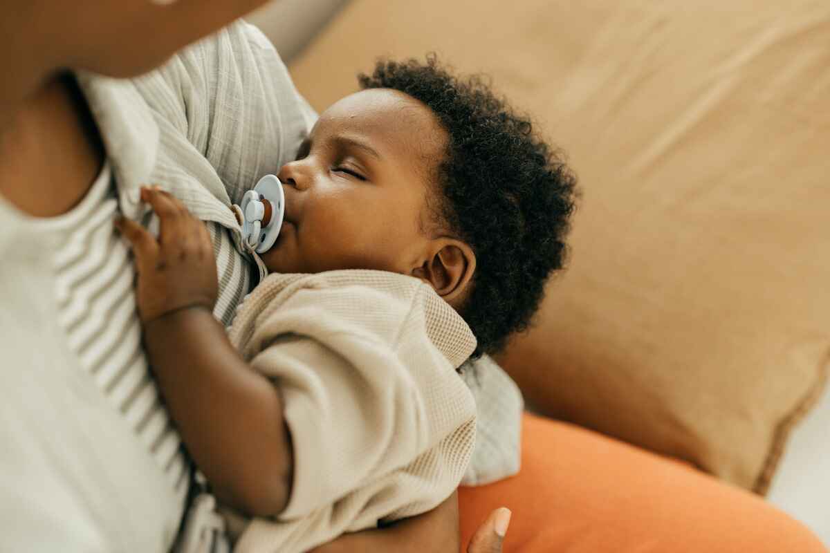 Mother holds baby having trouble sleeping